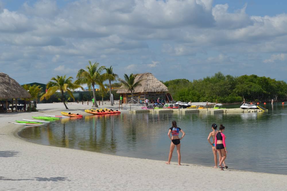 Tourists at a lagoon beach in Harvest Caye