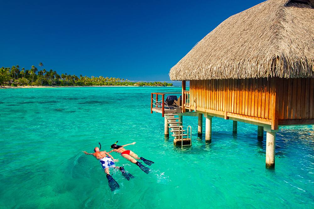 Tourists snorkeling, Bora, Bora