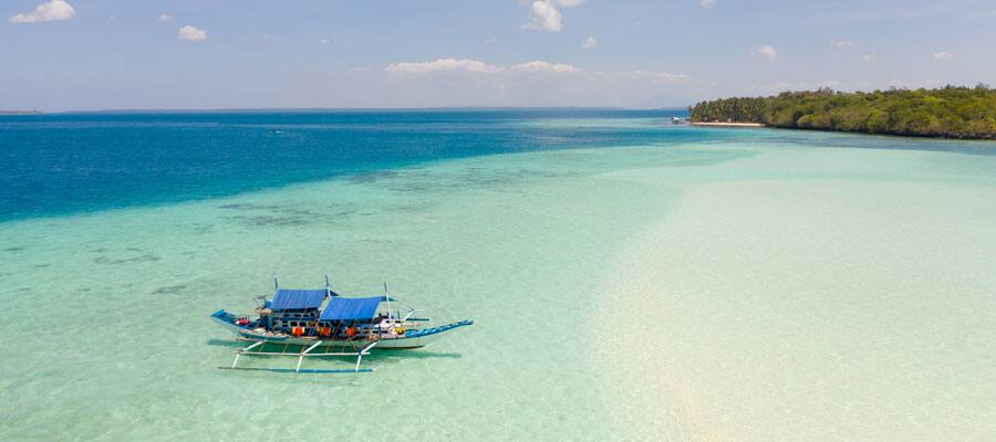 The shore near Puerto Princesa is full of Paraw, traditional double outrigger sa