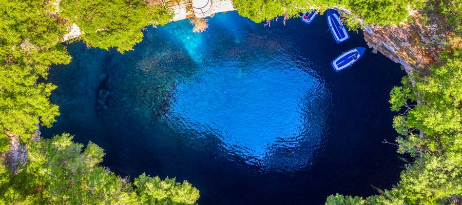 Take a boat ride through Melissani Lake, a deep blue pool inside of a cave. 