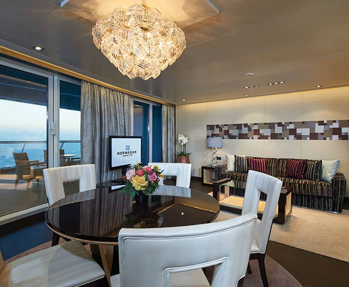The Haven's Deluxe Owners Suite with Large Balcony Living Room on Norwegian Escape