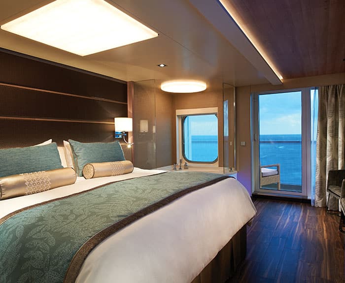 The Haven's Deluxe Spa Suite with Balcony bedroom on Norwegian Escape