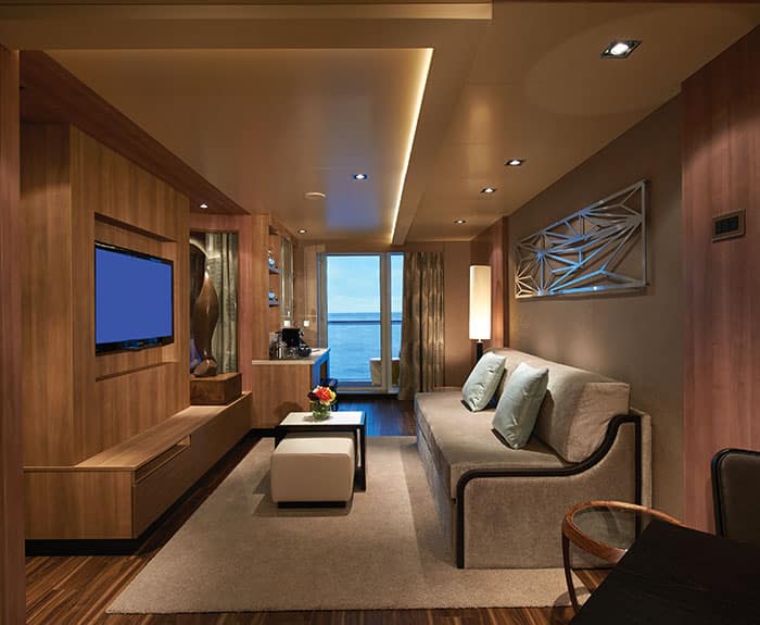 The Haven's Deluxe Spa Suite with Balcony living room on Norwegian Escape